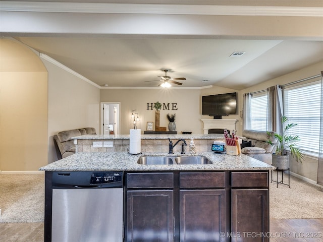 kitchen with dark brown cabinets, a sink, open floor plan, baseboards, and stainless steel dishwasher
