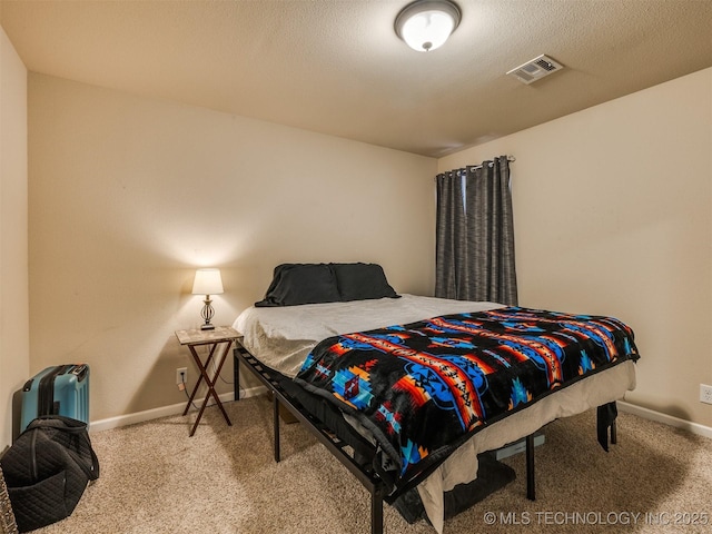 carpeted bedroom with baseboards and visible vents