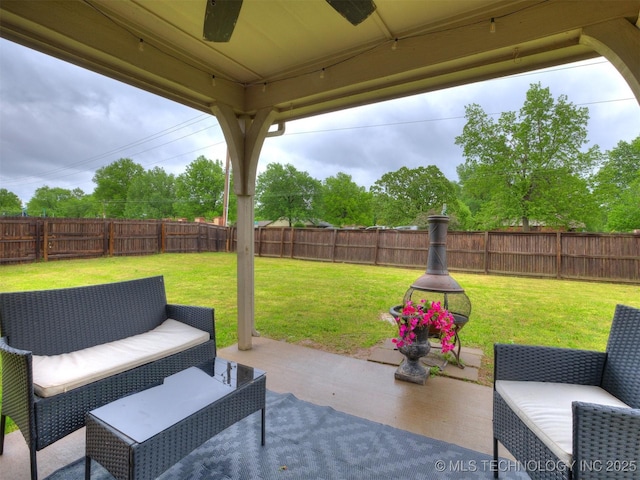 view of patio with a ceiling fan, a fenced backyard, and an outdoor hangout area