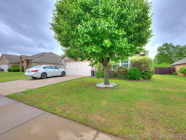 obstructed view of property featuring a garage, a front lawn, fence, and driveway