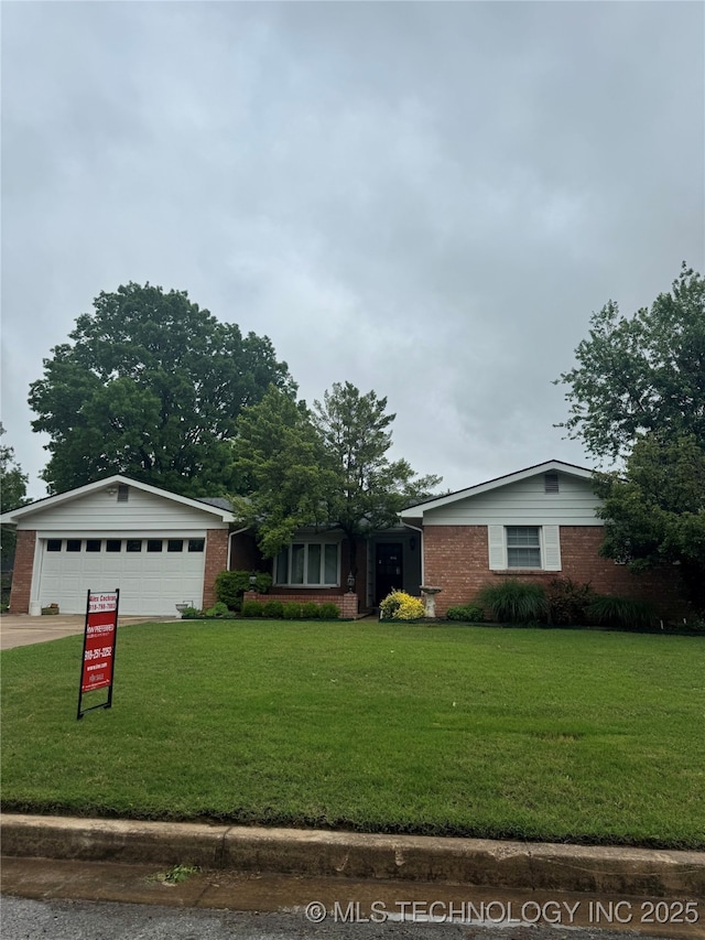 ranch-style house with brick siding, a front yard, and concrete driveway