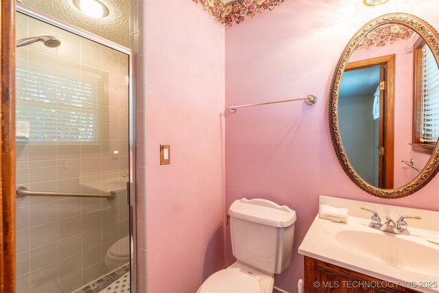 2305 S Hickory Pl, Broken Arrow, OK 74012 - full bathroom with a stall shower, toilet, vanity, and a textured ceiling