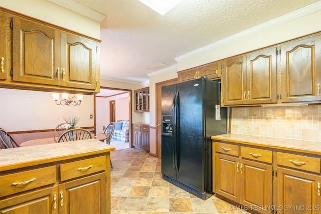 2305 S Hickory Pl, Broken Arrow, OK 74012 - kitchen featuring black fridge with ice dispenser, brown cabinetry, a textured ceiling, decorative backsplash, and light countertops