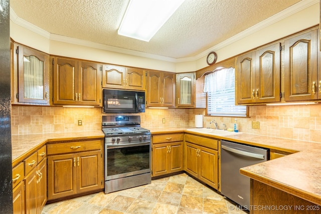 2305 S Hickory Pl, Broken Arrow, OK 74012 - kitchen with stainless steel appliances, a sink, a textured ceiling, brown cabinets, and ornamental molding