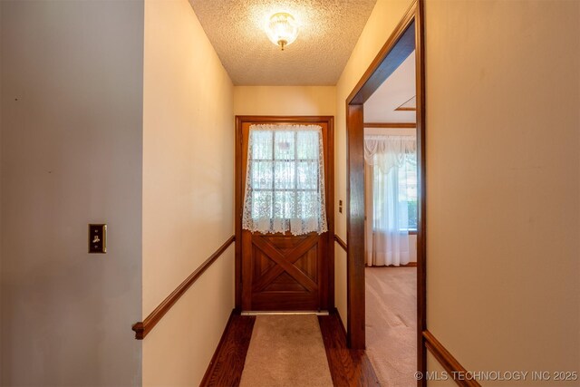 2305 S Hickory Pl, Broken Arrow, OK 74012 - entryway featuring a textured ceiling, carpet flooring, and baseboards