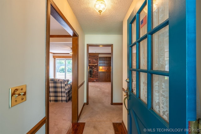2305 S Hickory Pl, Broken Arrow, OK 74012 - hall with light colored carpet, a textured ceiling, and baseboards