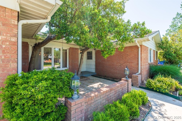 2305 S Hickory Pl, Broken Arrow, OK 74012 - view of exterior entry featuring brick siding and a patio area