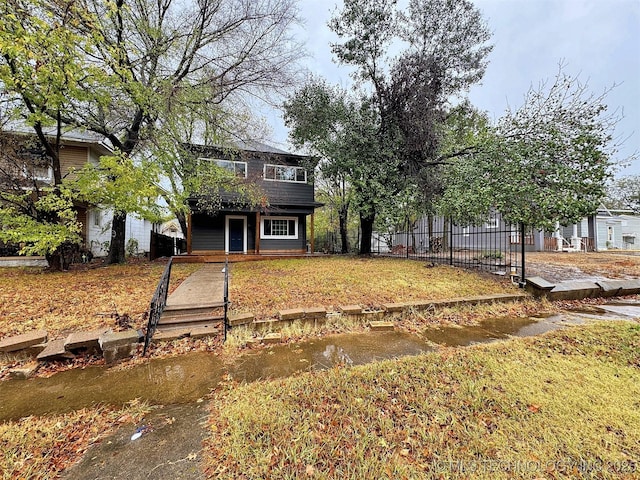 traditional-style house featuring fence