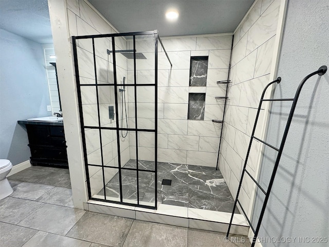 full bathroom featuring vanity, baseboards, toilet, and tiled shower