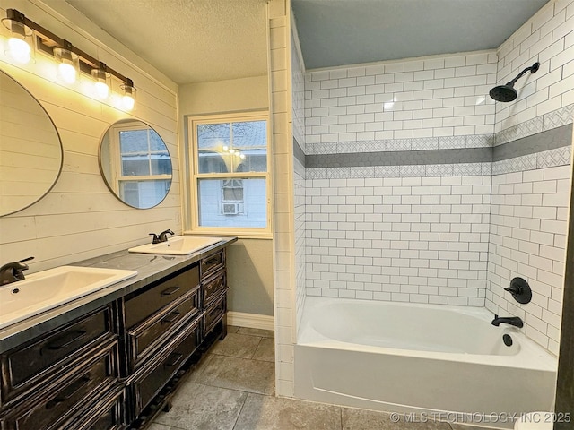 full bathroom featuring baseboards, a sink, washtub / shower combination, and tile patterned flooring