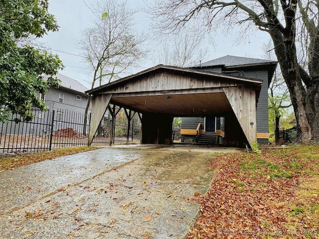 exterior space with fence, a carport, entry steps, and driveway