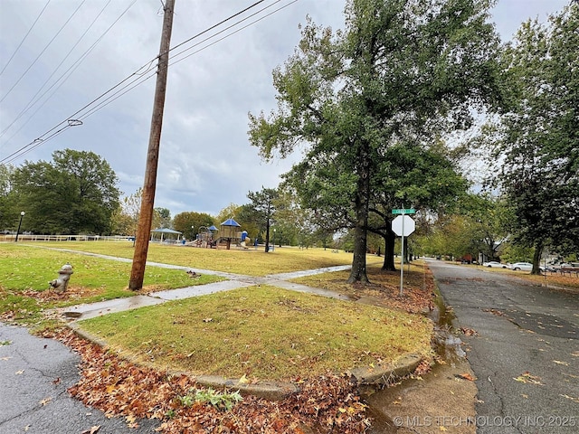 view of road featuring traffic signs and curbs