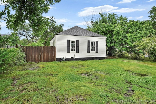 view of outbuilding with fence