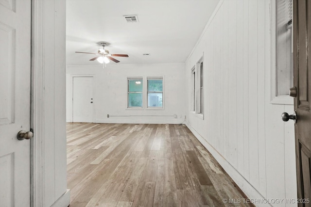 unfurnished room featuring ceiling fan, wood-type flooring, and visible vents