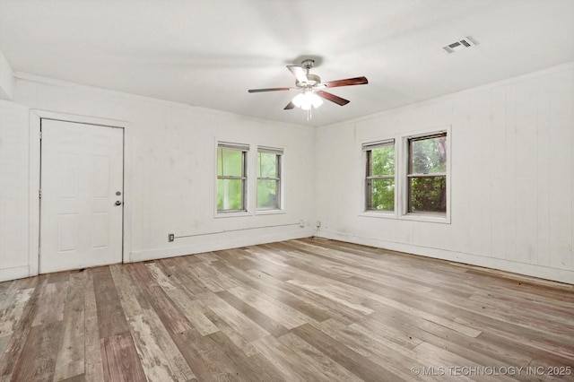unfurnished room featuring ceiling fan, visible vents, and wood finished floors