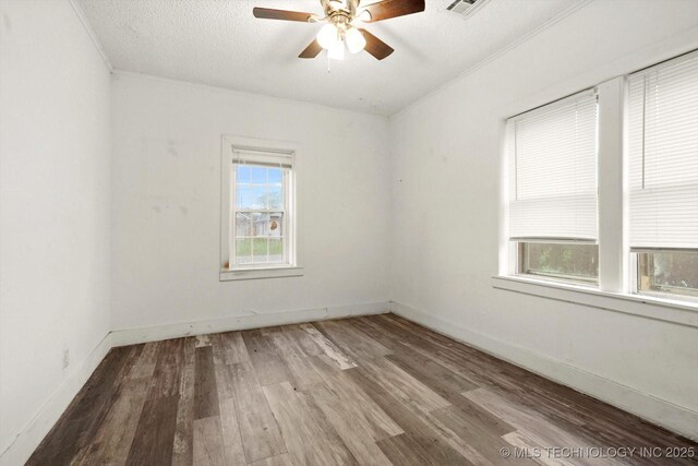 5031 S 30th W Ave, Tulsa, OK 74107 - empty room with crown molding, ceiling fan, visible vents, and wood finished floors
