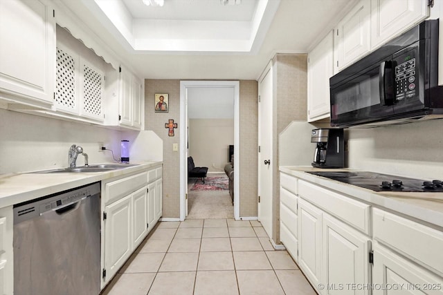 kitchen featuring white cabinets, a sink, and black appliances
