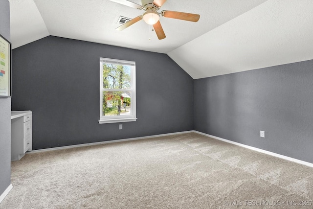 bonus room with carpet floors, visible vents, baseboards, a ceiling fan, and vaulted ceiling