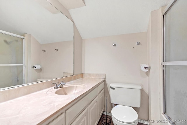 bathroom featuring a shower with shower door, vaulted ceiling, and toilet