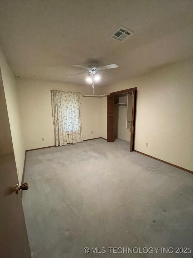 unfurnished bedroom featuring visible vents, a closet, light carpet, baseboards, and ceiling fan