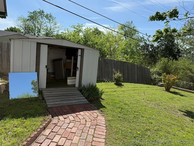 exterior space with fence, an outdoor structure, and a storage unit