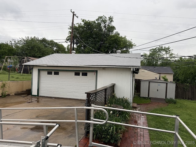 detached garage featuring fence