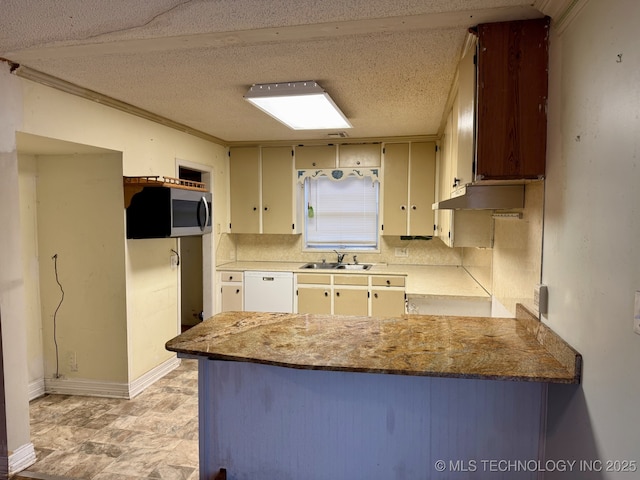 kitchen with a textured ceiling, white dishwasher, a sink, stainless steel microwave, and a peninsula