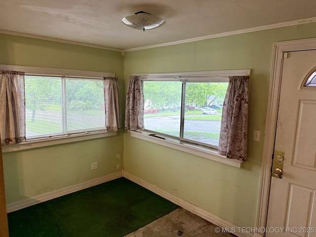 spare room featuring baseboards and ornamental molding