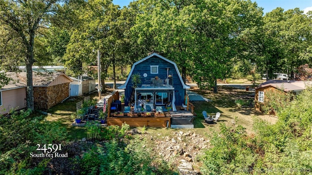 24591 S 613th Rd, Grove, OK 74344 - rear view of house featuring a deck, an outbuilding, and a gambrel roof