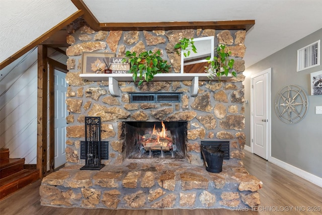24591 S 613th Rd, Grove, OK 74344 - living area with a stone fireplace, baseboards, wood finished floors, and visible vents