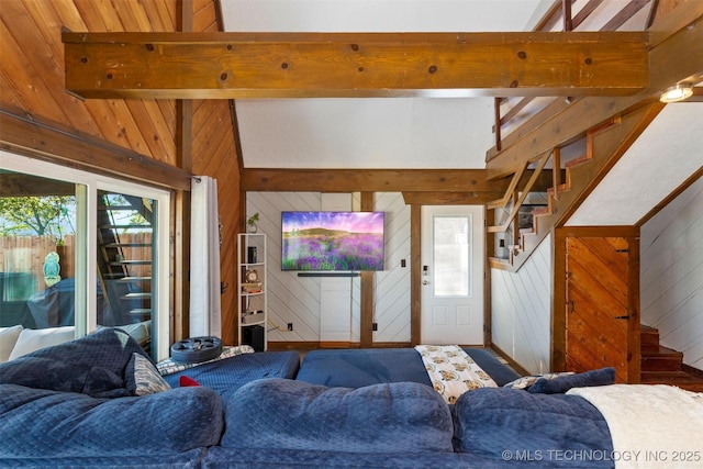24591 S 613th Rd, Grove, OK 74344 - living room featuring wood walls, plenty of natural light, and stairway