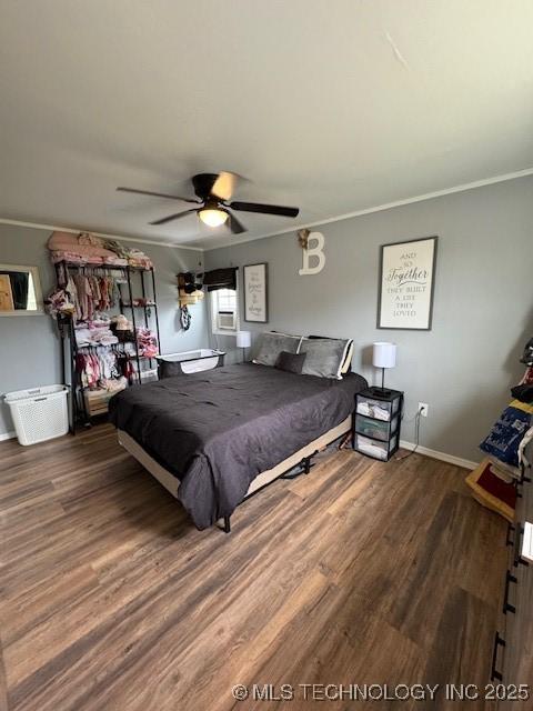 bedroom featuring baseboards, ceiling fan, ornamental molding, and wood finished floors