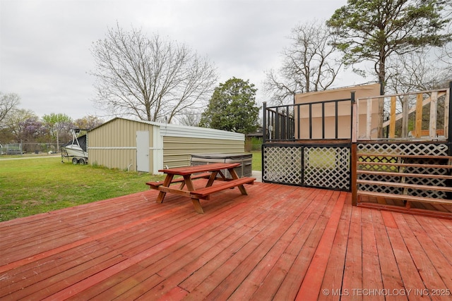 wooden deck with an outdoor structure and a yard
