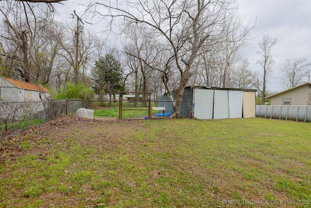 view of yard with an outdoor structure and a fenced backyard