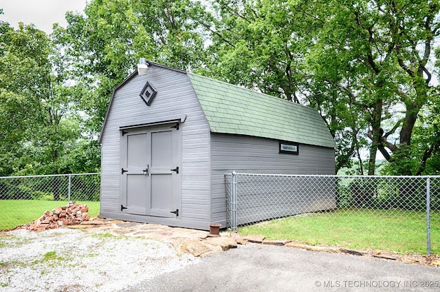 view of shed featuring fence