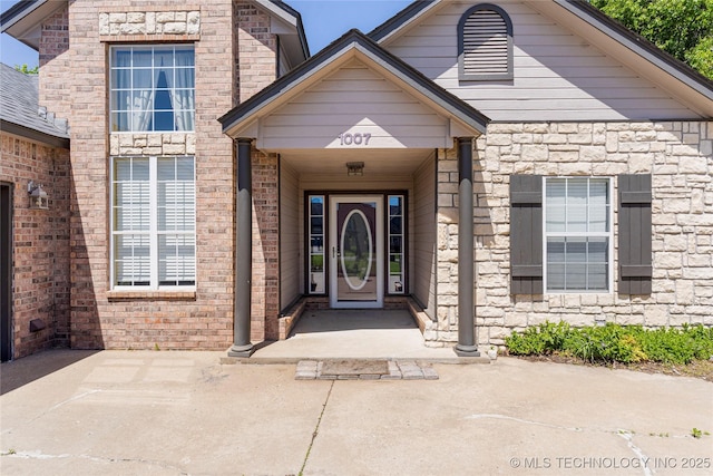 entrance to property with stone siding
