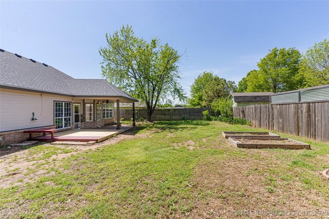 1007 W Beech St, Skiatook, OK 74070 - view of yard with a fenced backyard, a patio area, and a vegetable garden