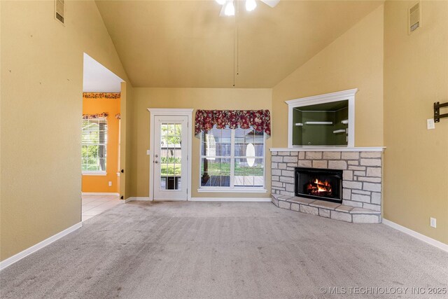 1007 W Beech St, Skiatook, OK 74070 - unfurnished living room with ceiling fan, a stone fireplace, visible vents, baseboards, and carpet