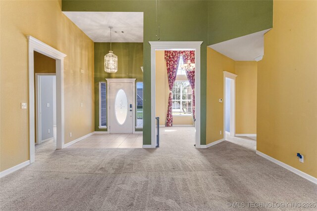 1007 W Beech St, Skiatook, OK 74070 - carpeted entrance foyer featuring baseboards and a towering ceiling