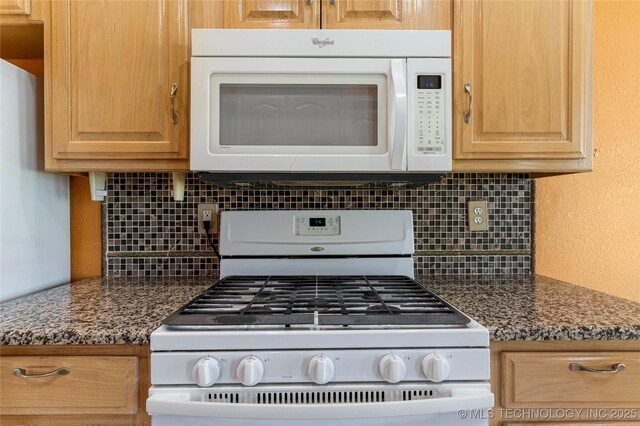 1007 W Beech St, Skiatook, OK 74070 - kitchen featuring dark countertops, backsplash, white appliances, and light brown cabinetry