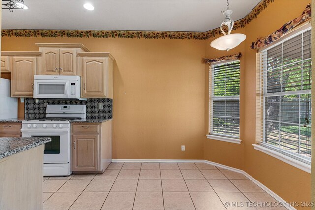 1007 W Beech St, Skiatook, OK 74070 - kitchen with light brown cabinetry, white appliances, dark stone counters, light tile patterned floors, and backsplash