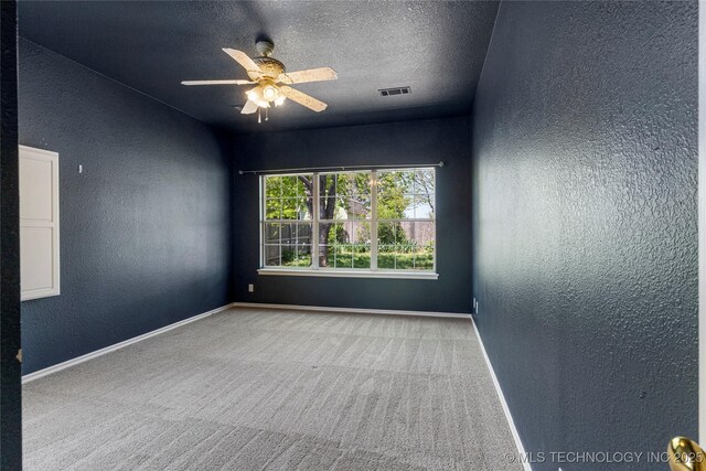 1007 W Beech St, Skiatook, OK 74070 - empty room featuring a textured wall, carpet, a ceiling fan, baseboards, and visible vents