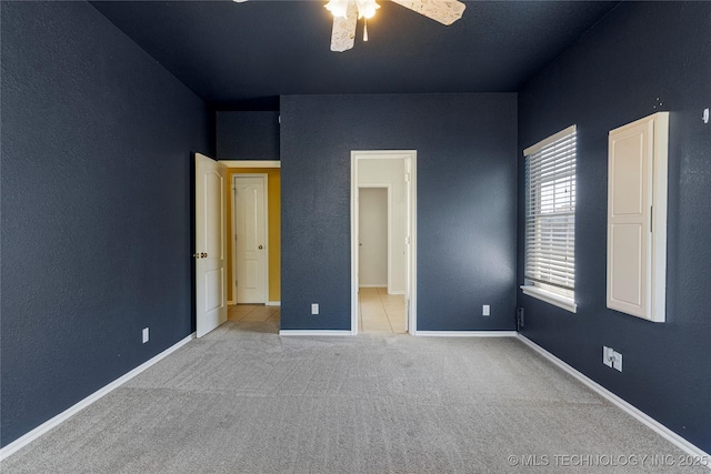 unfurnished bedroom featuring carpet flooring and baseboards