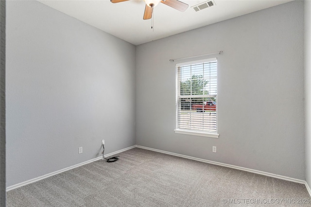 unfurnished room with visible vents, a ceiling fan, carpet, and baseboards