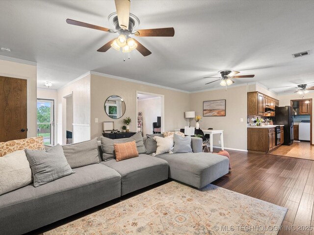 living room with visible vents, a ceiling fan, crown molding, and wood finished floors