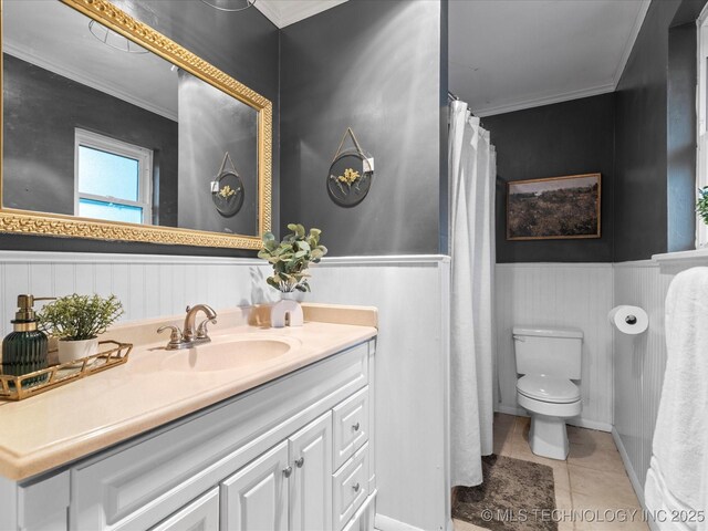 full bath featuring vanity, wainscoting, tile patterned floors, and toilet