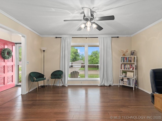 living area featuring crown molding, a ceiling fan, baseboards, and hardwood / wood-style flooring
