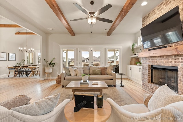 living area with baseboards, a fireplace, beam ceiling, and a wealth of natural light