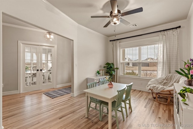 dining space featuring baseboards, a ceiling fan, light wood finished floors, and visible vents