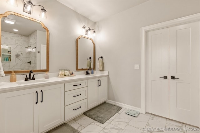 full bath featuring double vanity, a sink, marble finish floor, and a shower stall
